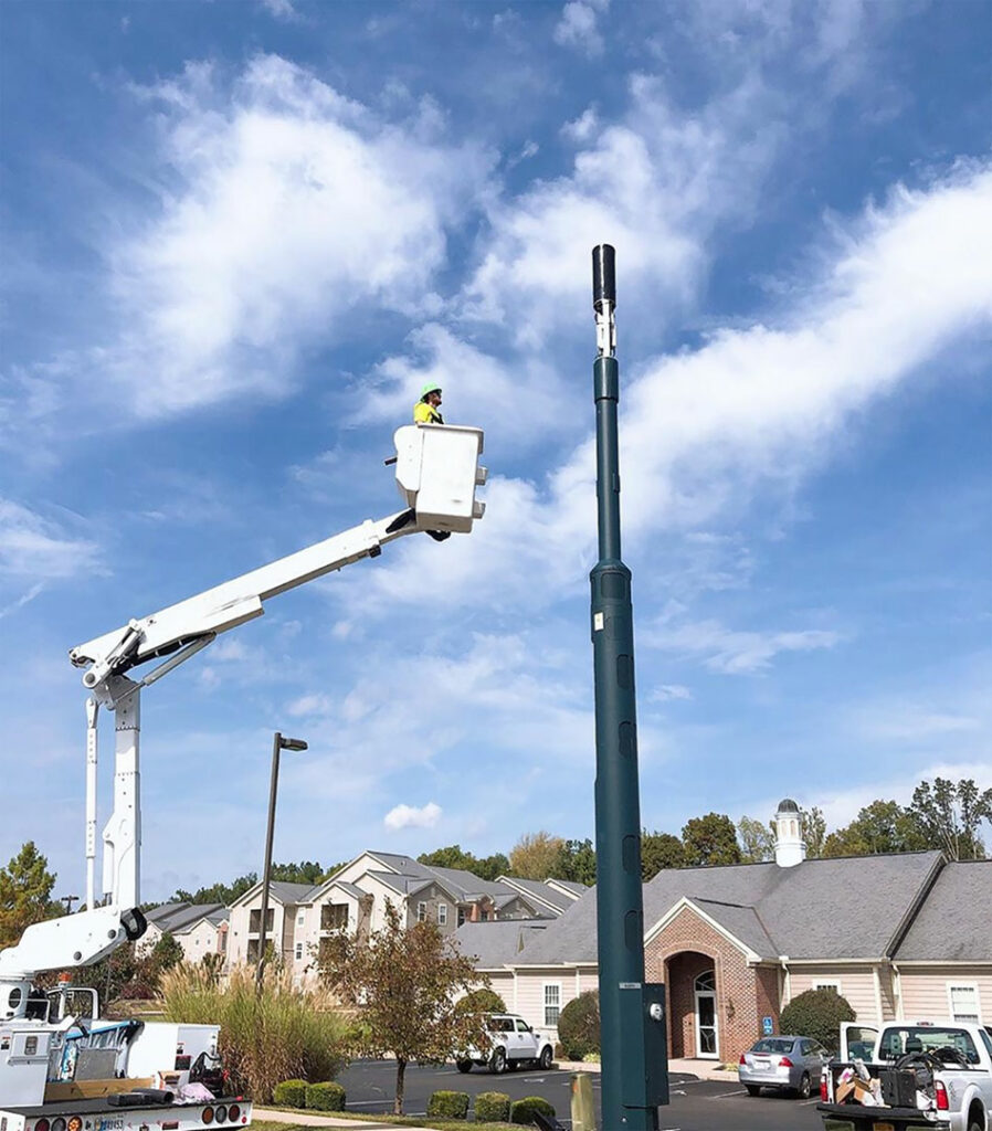 Tilson worker installing utility pole